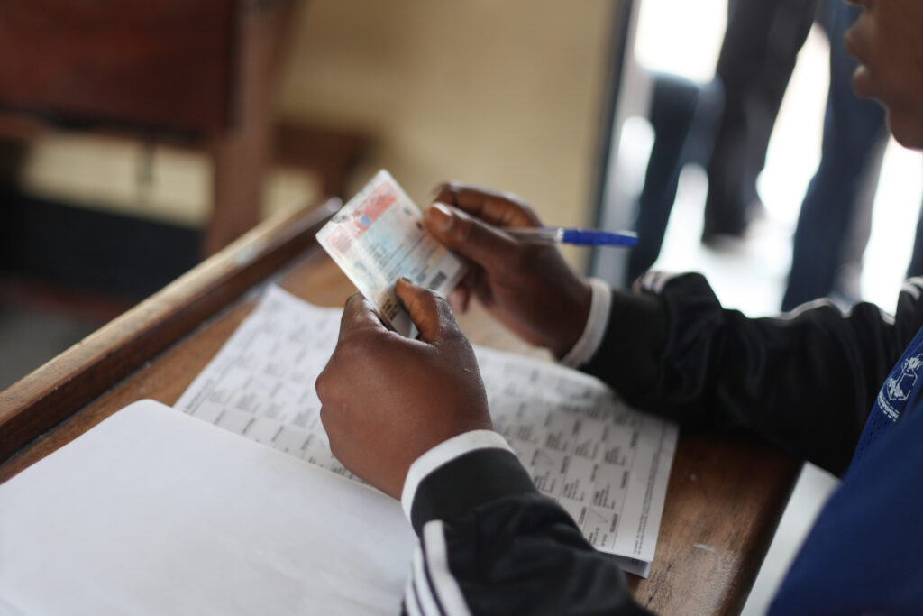 By MONUSCO Photos - Verification of voting card, CC BY-SA 2.0, Link