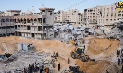 हमास के सशस्त्र समूह के सदस्य दक्षिणी गजा पट्टी के खान यूनिस में बंधकों के शवों की तलाश करते हुए।