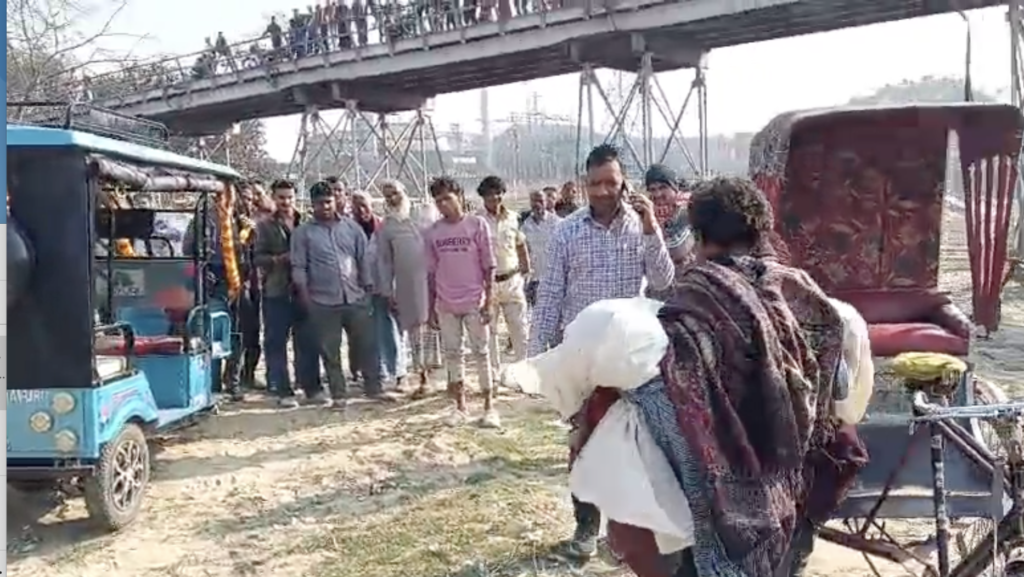 लोगों के हंगामा करने पर शव को रिक्शे से ईरिक्शे में रखता चालक, रेलवे पुलिस ने इसी को शव नदी में बहाने के लिए रुपये दिए थे।